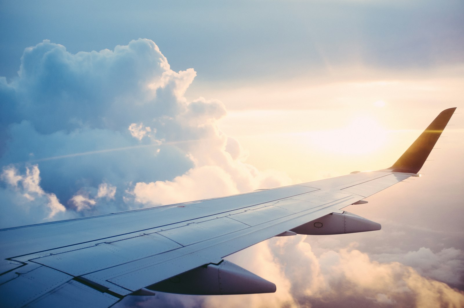 An aircraft wing above the clouds